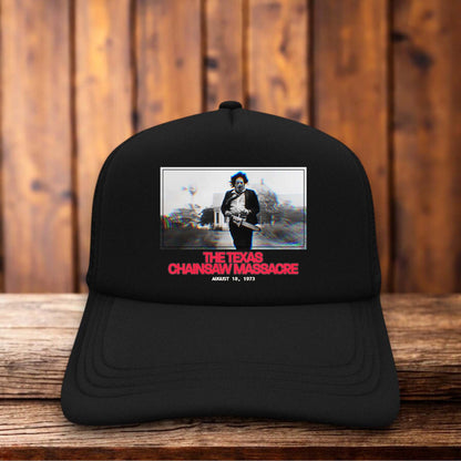 Retro trucker hat featuring the 1973 Texas Chainsaw Massacre title logo in weathered vintage typography on a structured foam front.