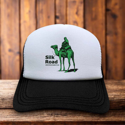 A retro trucker hat with a white foam front featuring the original green Silk Road camel logo and pixelated marketplace typography.