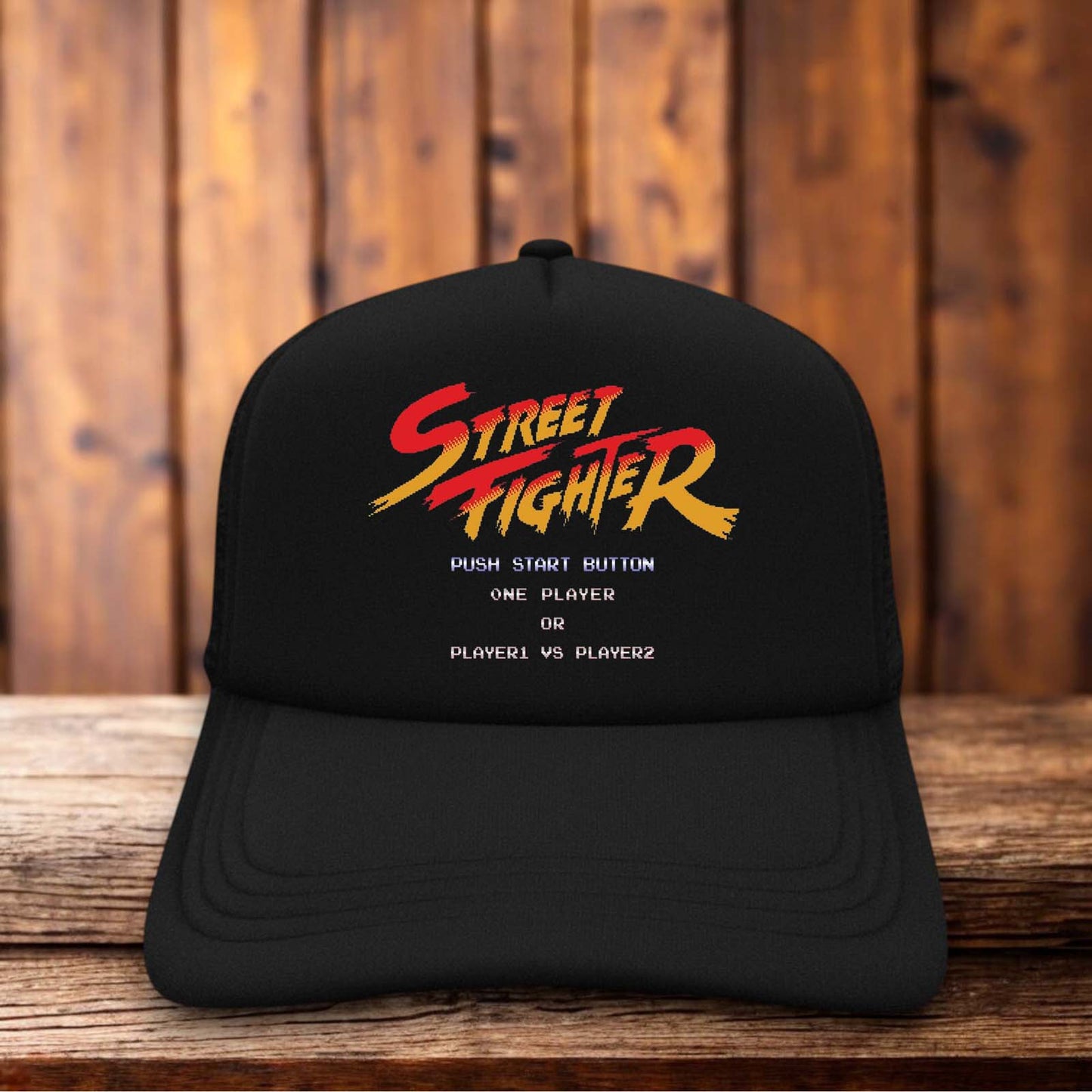 Retro trucker hat with a structured foam front featuring the classic 1987 Street Fighter arcade logo and vintage fighting game graphics.