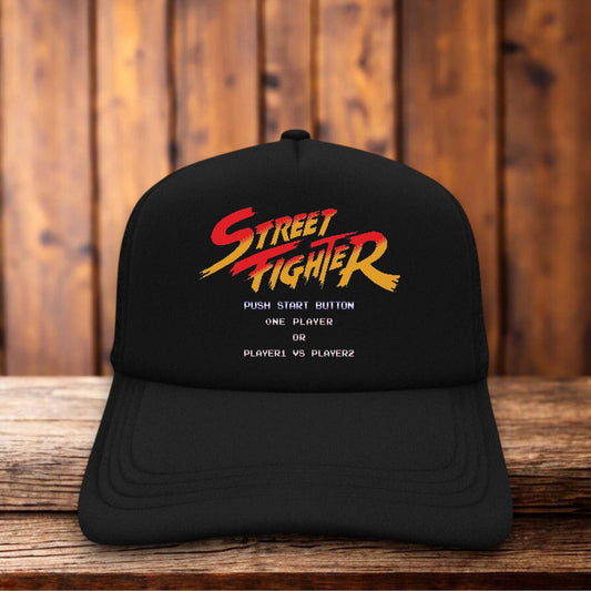 Retro trucker hat with a structured foam front featuring the classic 1987 Street Fighter arcade logo and vintage fighting game graphics.