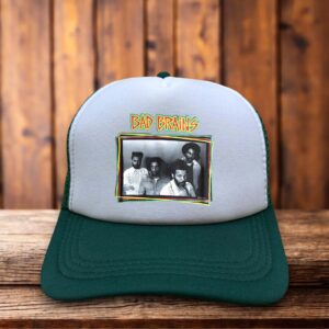 A dark green trucker hat featuring the iconic Bad Brains lightning bolt and Capitol building logo in yellow and black on a structured foam front.