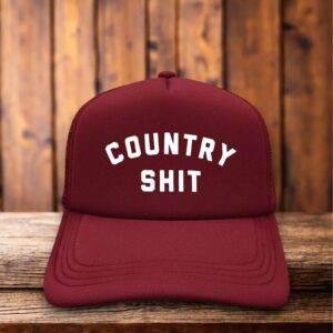 A two-toned vintage-style trucker hat with "Country Shit" in bold, distressed typography.