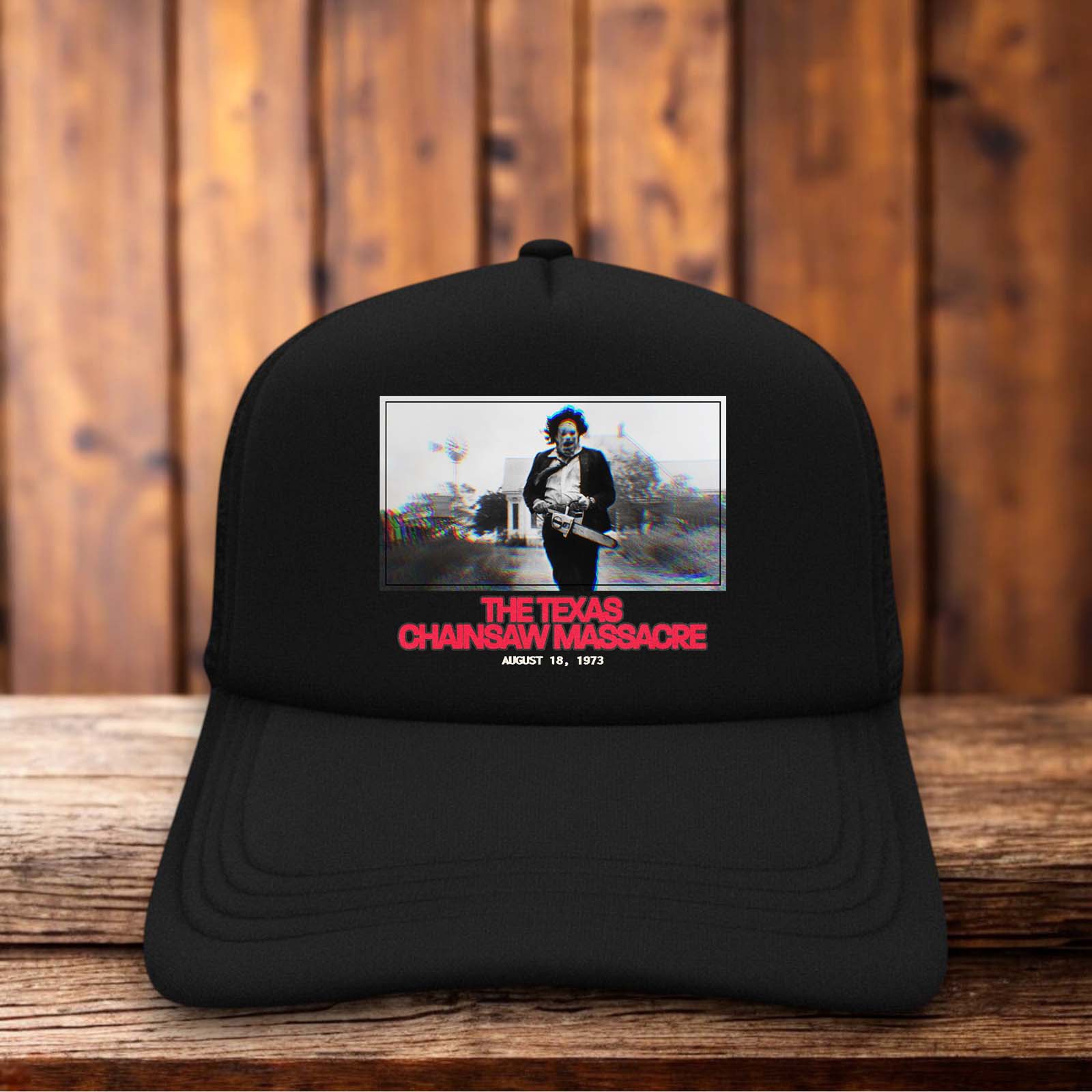 Retro trucker hat featuring the 1973 Texas Chainsaw Massacre title logo in weathered vintage typography on a structured foam front.