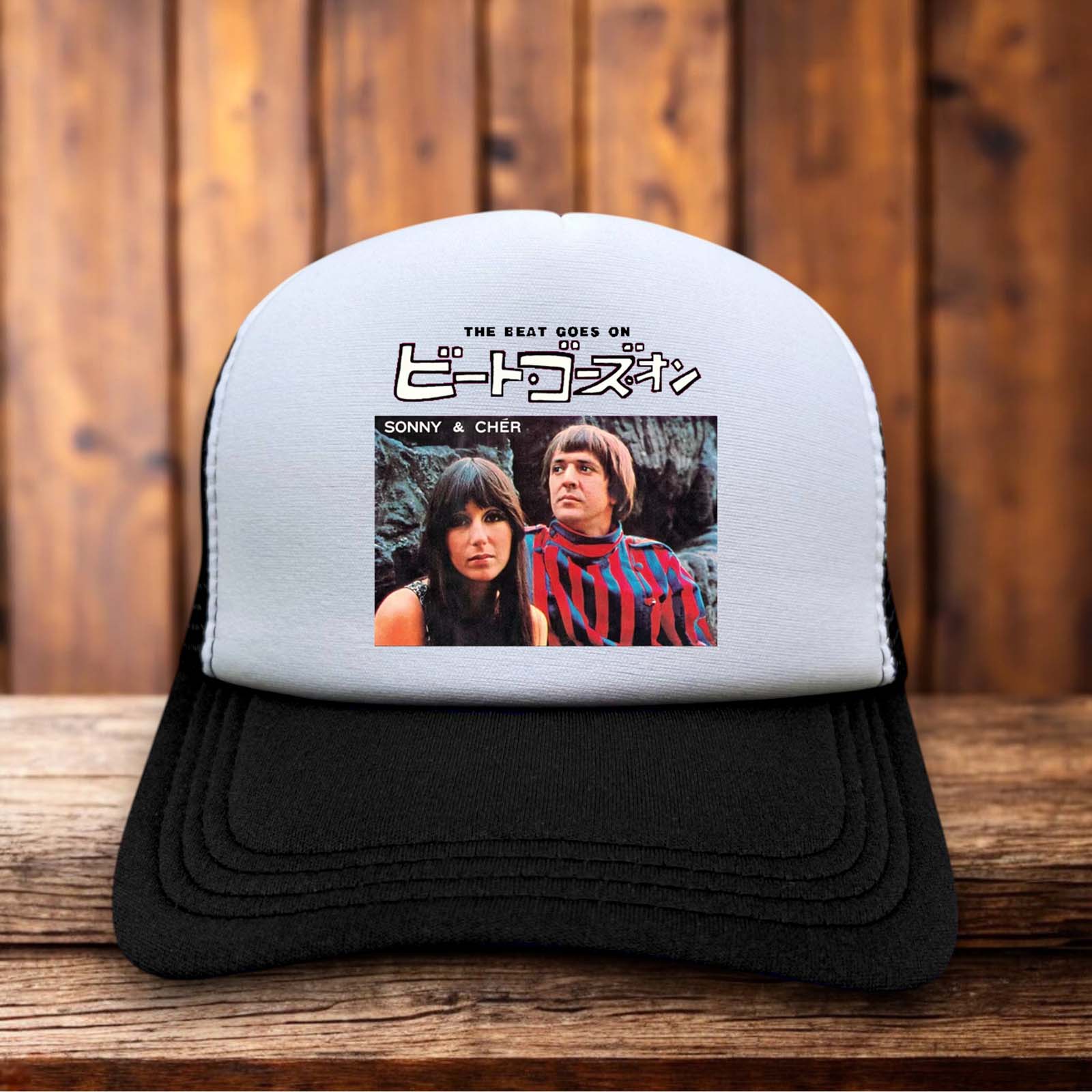 Retro trucker hat featuring "The Beat Goes On" in 60s bubble font with Japanese characters below it on a structured foam front.