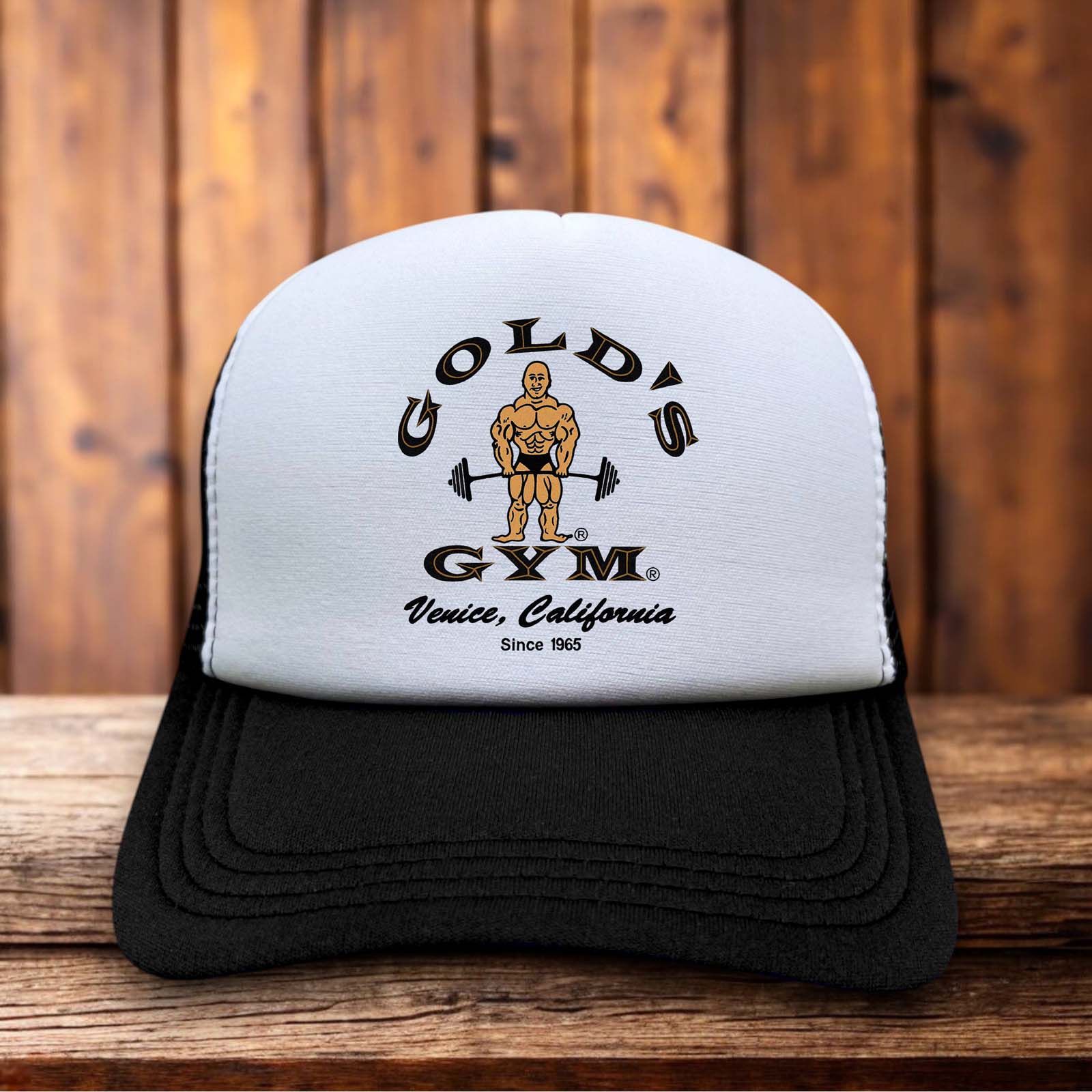 A vintage-style trucker hat featuring the yellow and black Gold’s Gym Venice California logo