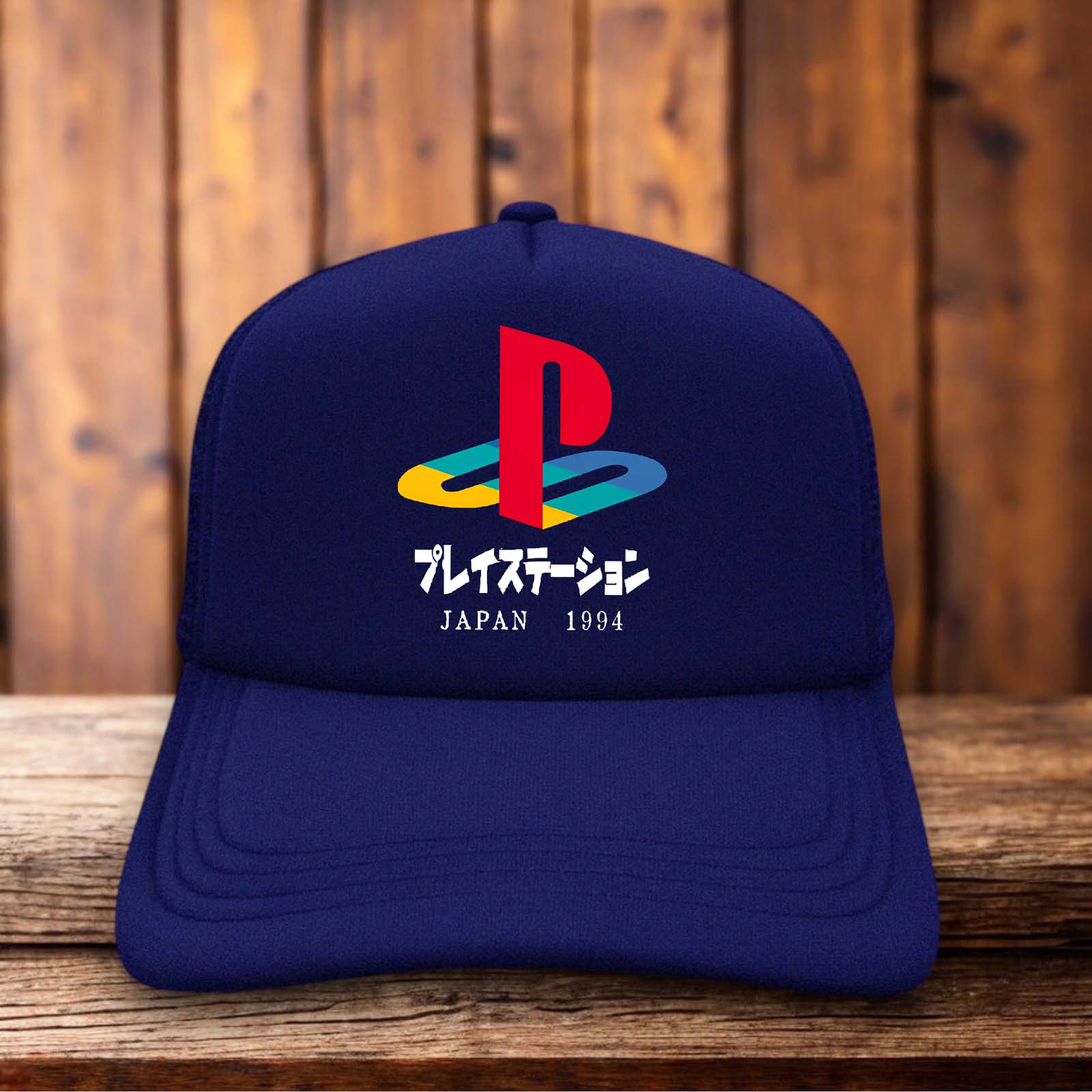 A retro trucker hat with a white foam front featuring the original four-color Playstation logo and 1994 Japanese launch text.