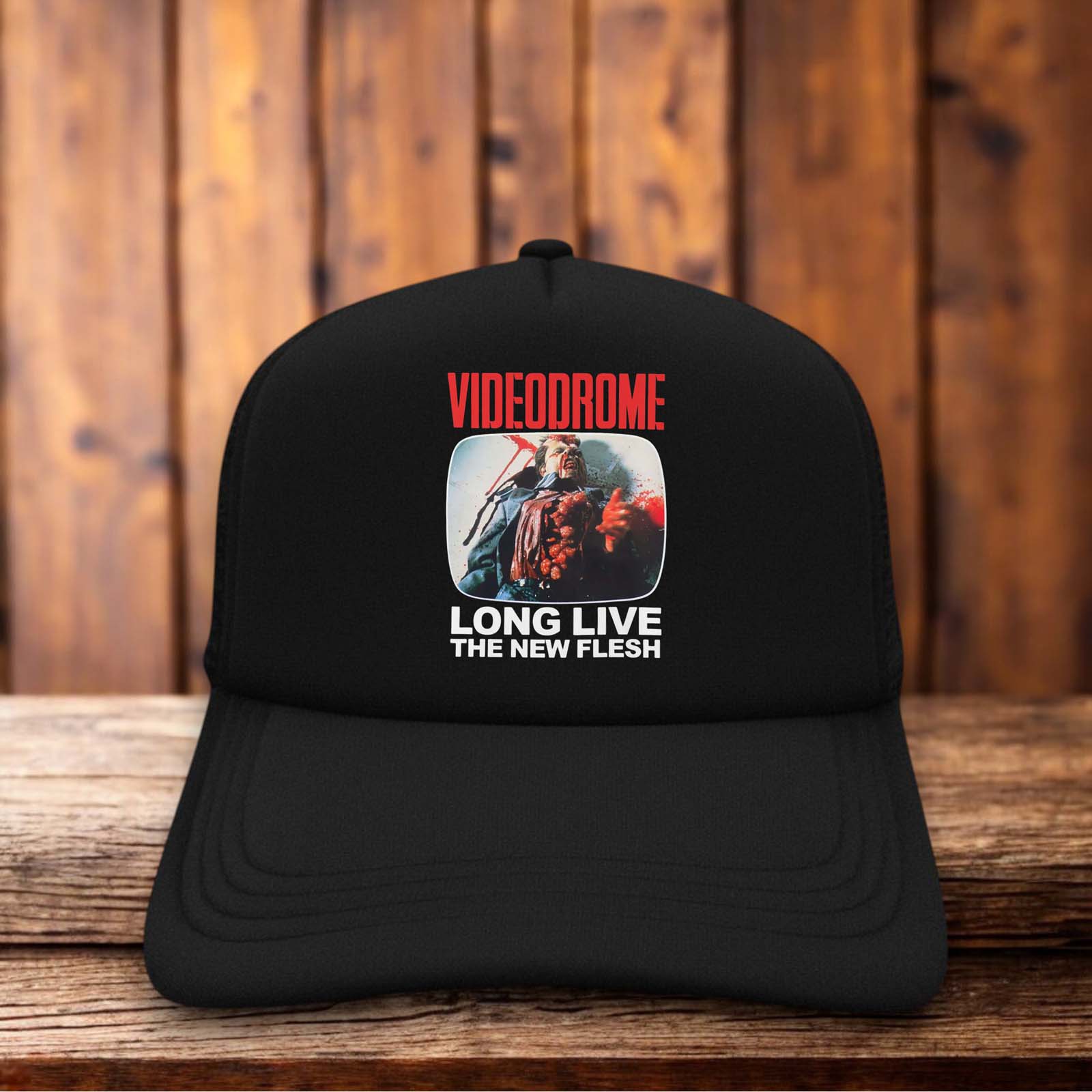 A retro trucker hat featuring the iconic Videodrome "V" logo with a warped, static-effect design on a structured foam front.