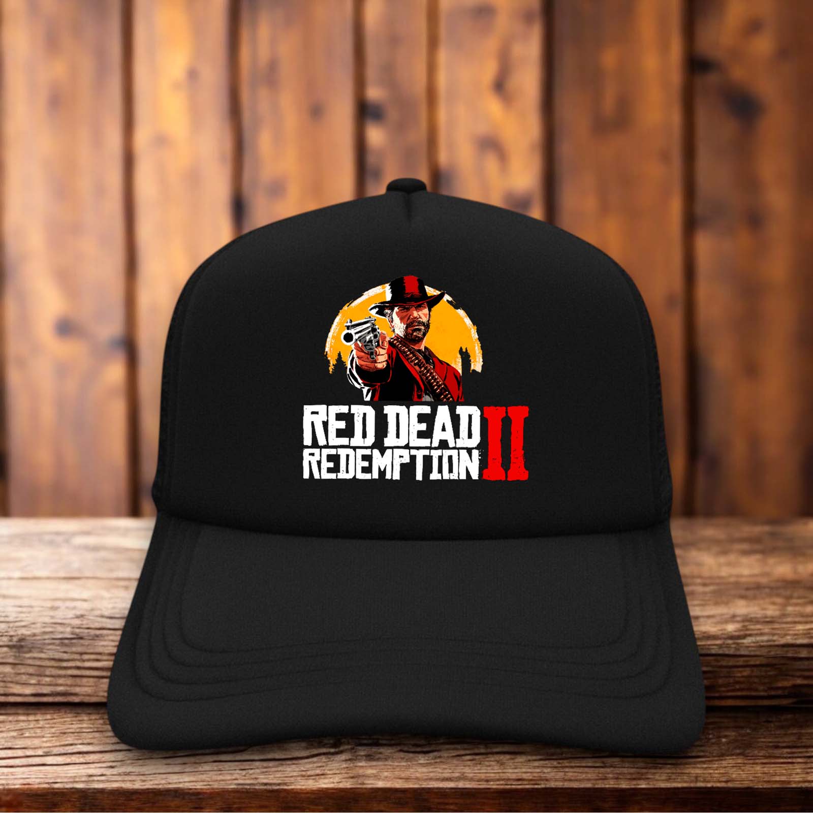 A retro trucker hat featuring the iconic Red Dead Redemption 2 silhouette of outlaws against a sunset on a structured foam front.