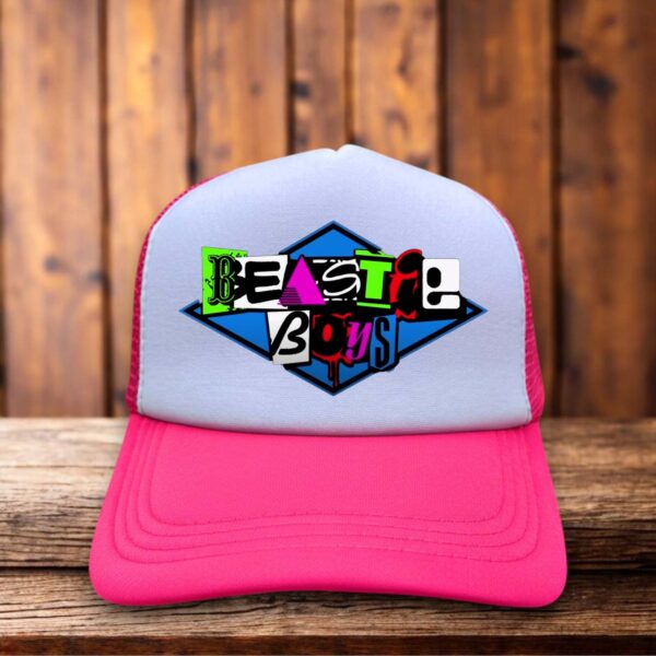 Neon pink retro trucker hat featuring the Beastie Boys logo in bold vintage-style typography on a structured foam front.