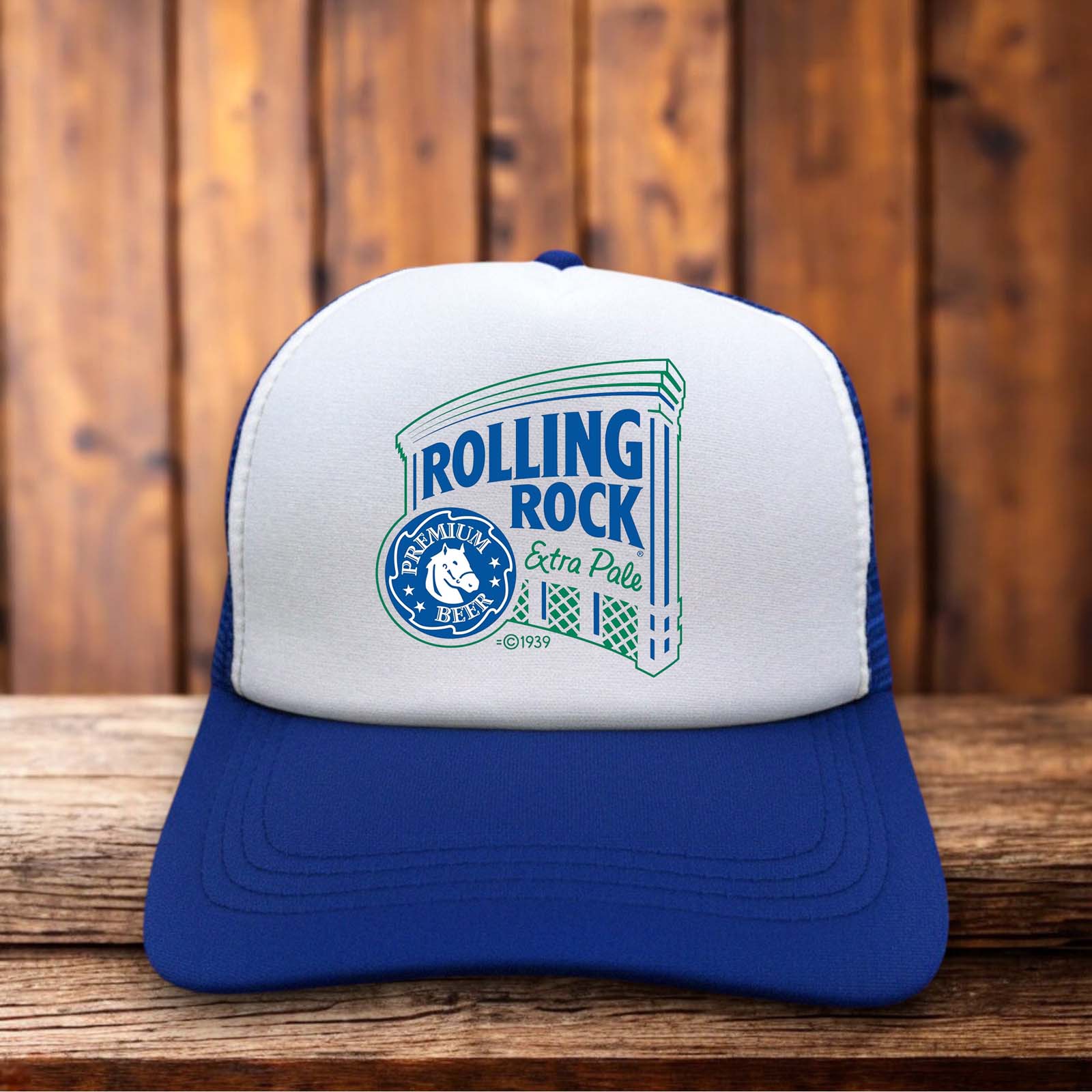 A classic trucker hat with a forest green foam front featuring the iconic white Rolling Rock horse head logo and "33" branding in a retro 1970s style.