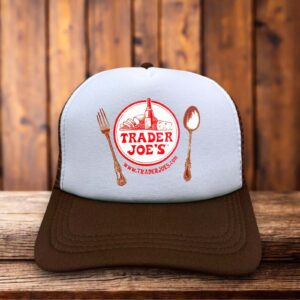A classic trucker hat with a white foam front featuring a rare, vintage-style Trader Joe's logo in bold red and tropical-inspired typography.