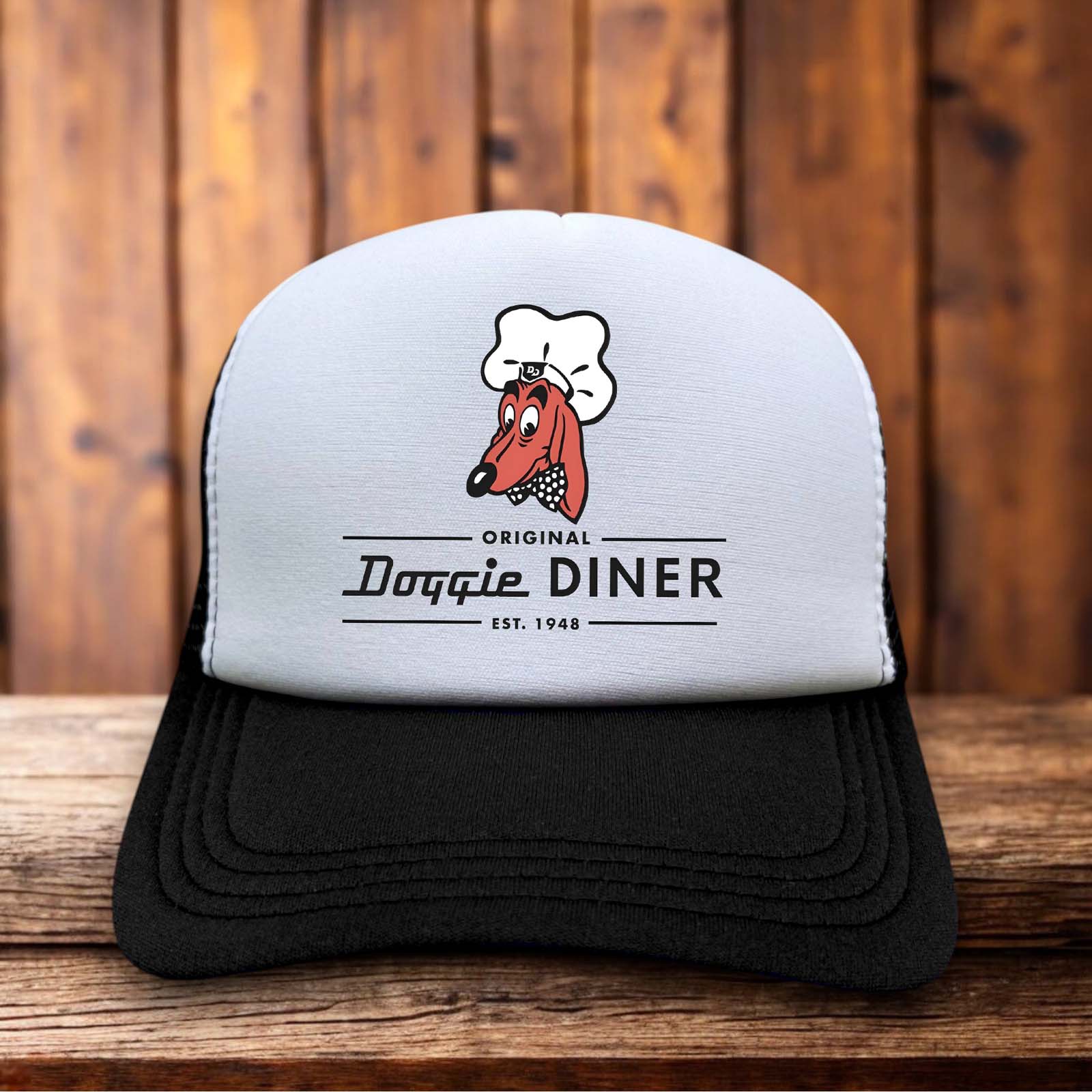 A retro trucker hat with a white foam front featuring the iconic Doggie Diner dachshund head logo with a chef hat and bowtie.
